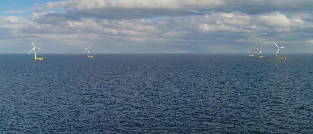  A long distance view of multiple offshore floating wind turbines
