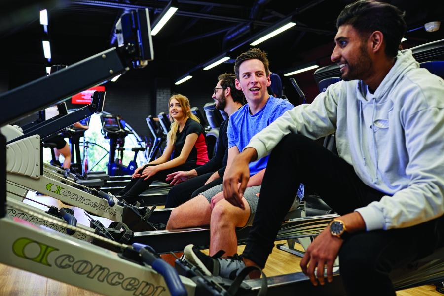 Students on the rowing machines at the Canolfan Brailsford gym