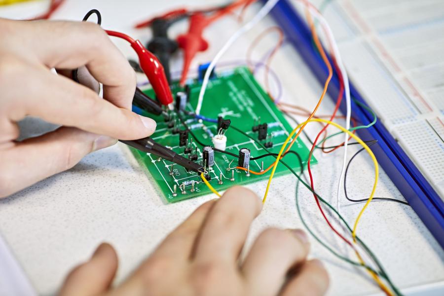 Close-up of a person working on a electrical circuit