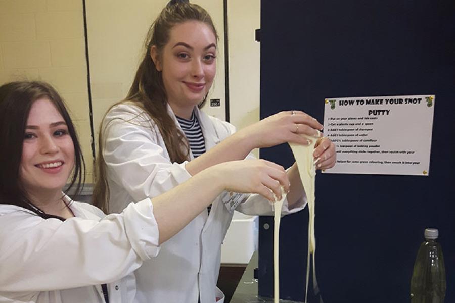 Two students holding up slime they made at the Bangor Science Festival