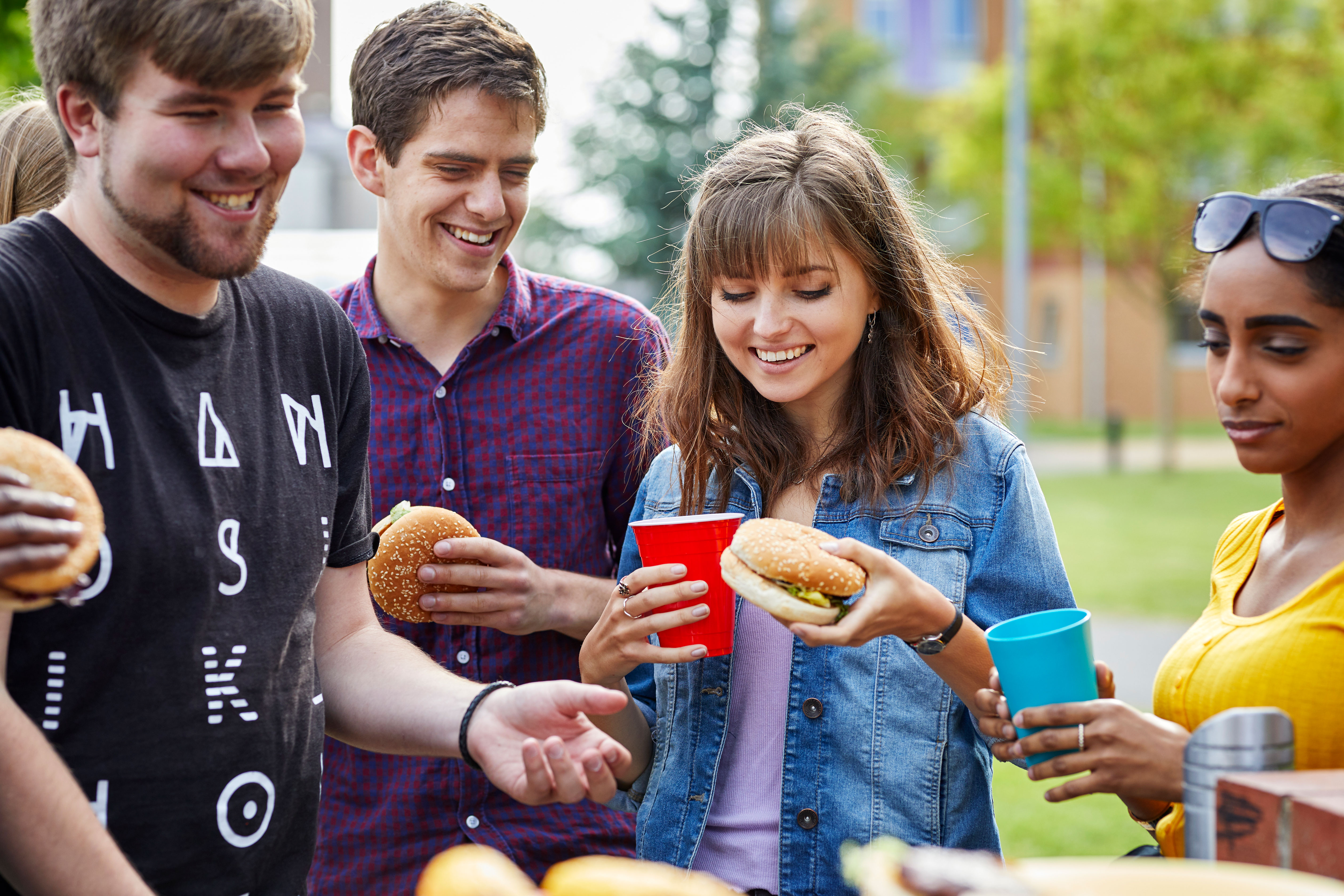 Students enjoying a BBQ outside halls of residence at the Ffriddoedd Student Village