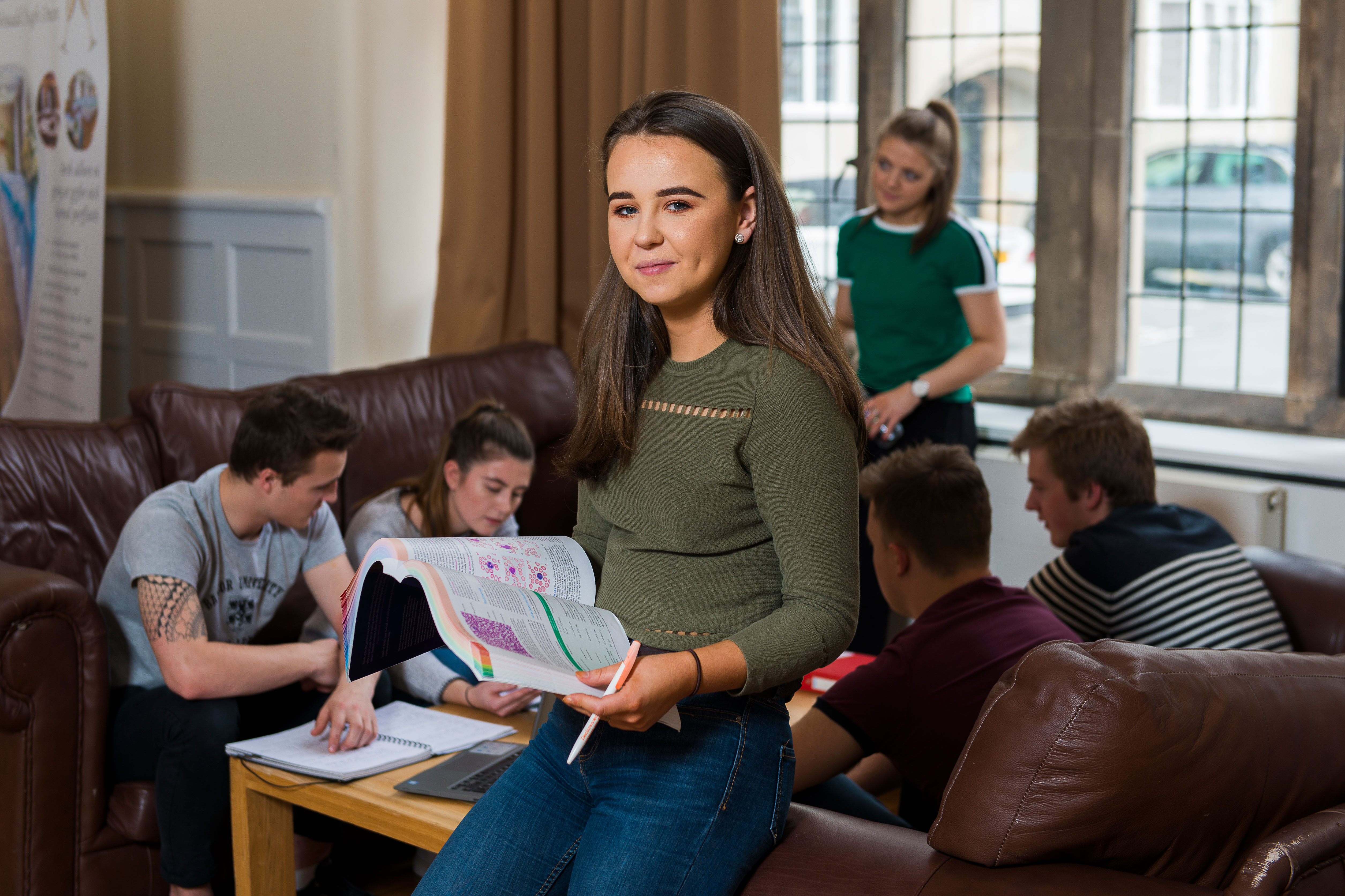 Students sitting on the wall in the inner quad of the Main Arts Building