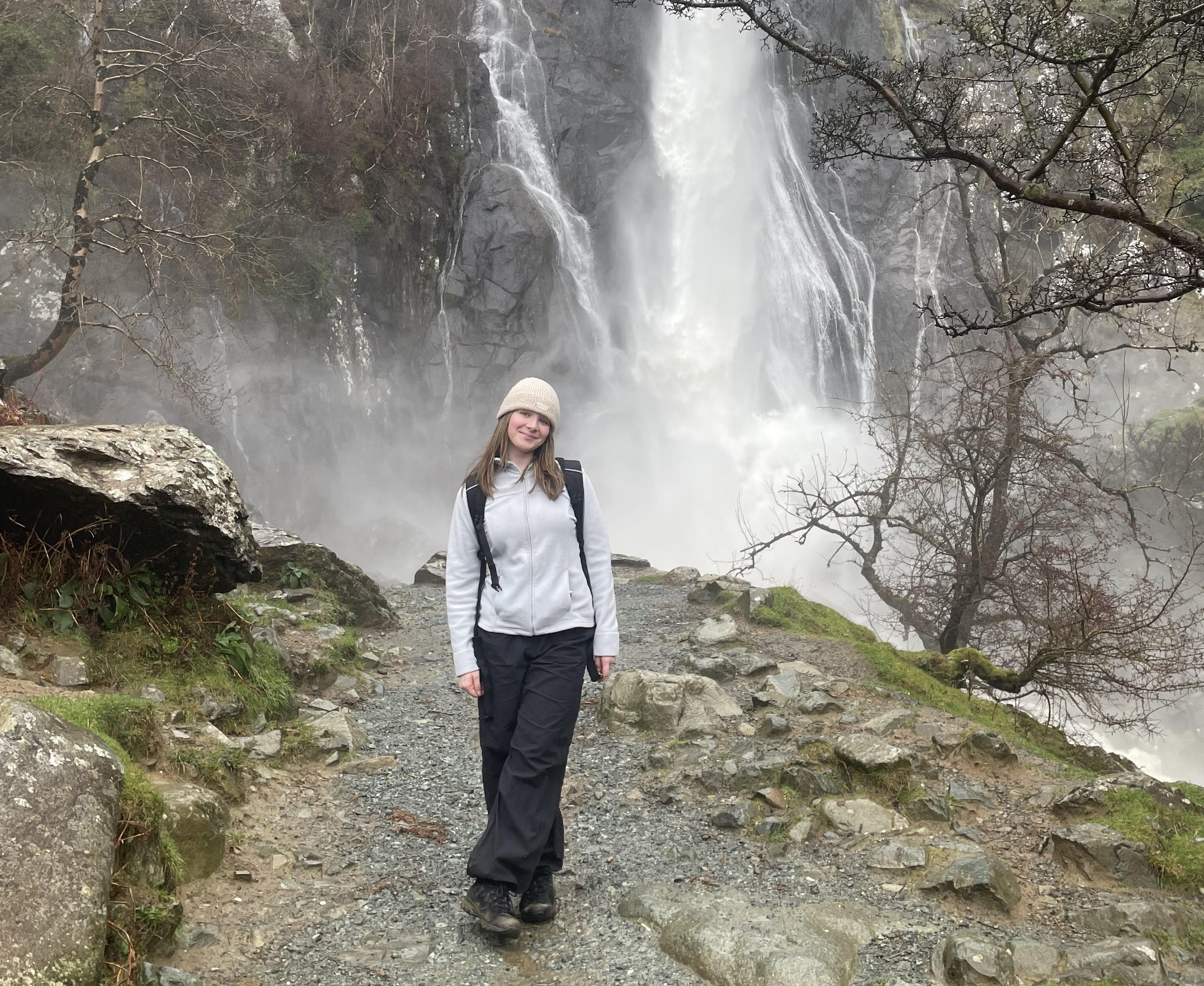 Megan Judge standing in front of a waterfall