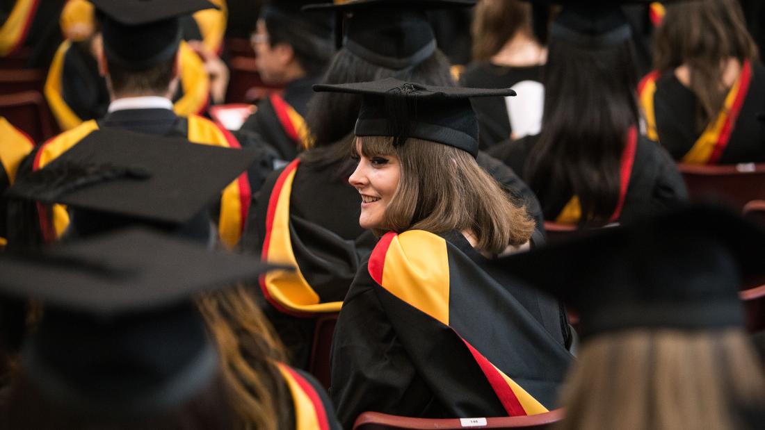 Students sitting in PJ Hall in the Main Arts Building on Graduation day