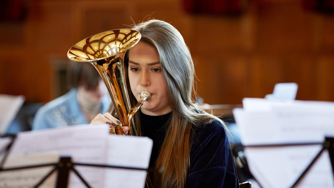 Student playing musical instrument