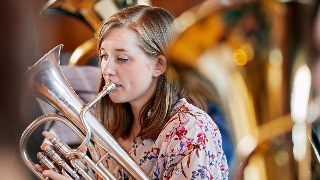 Student playing musical instrument in an orchestra