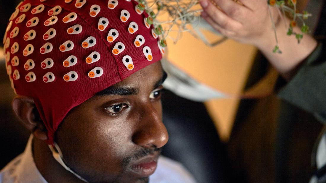 Student wearing a headpiece in a psychology study