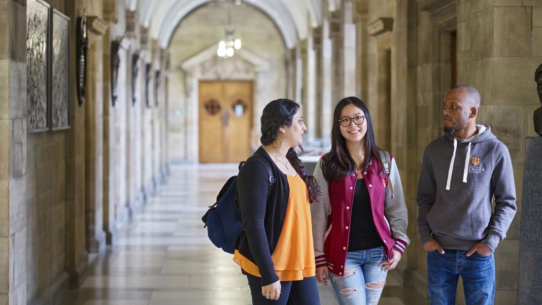 Students walking through a corridor at the Main Arts Building