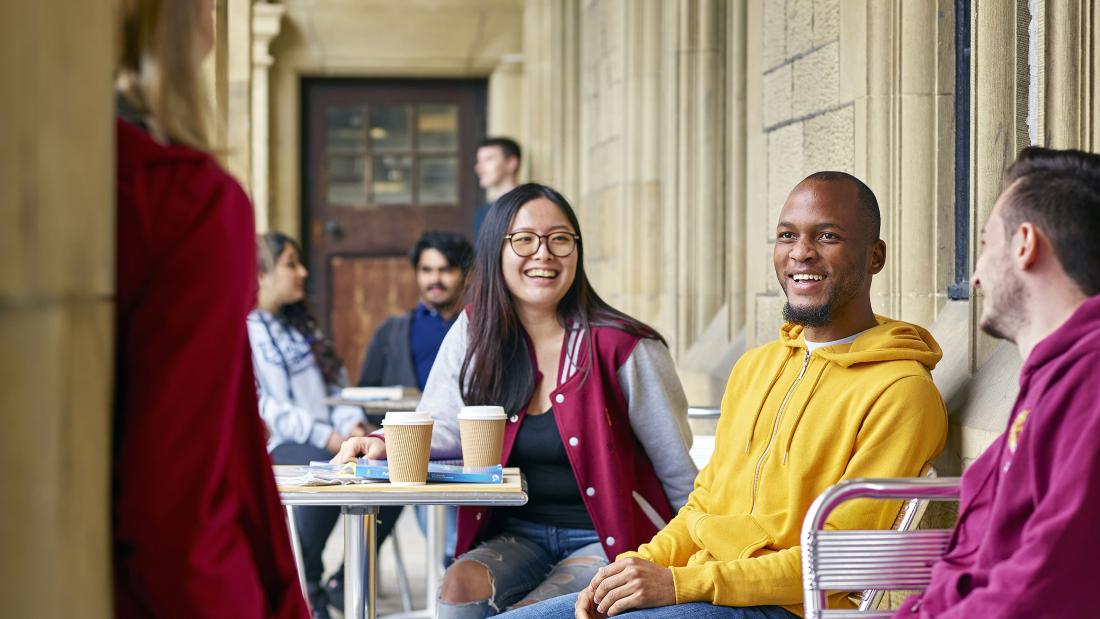 A group of students socialising outside the Main Arts Building 