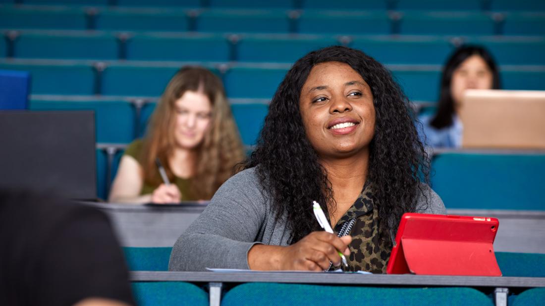 A student taking notes during a lecture