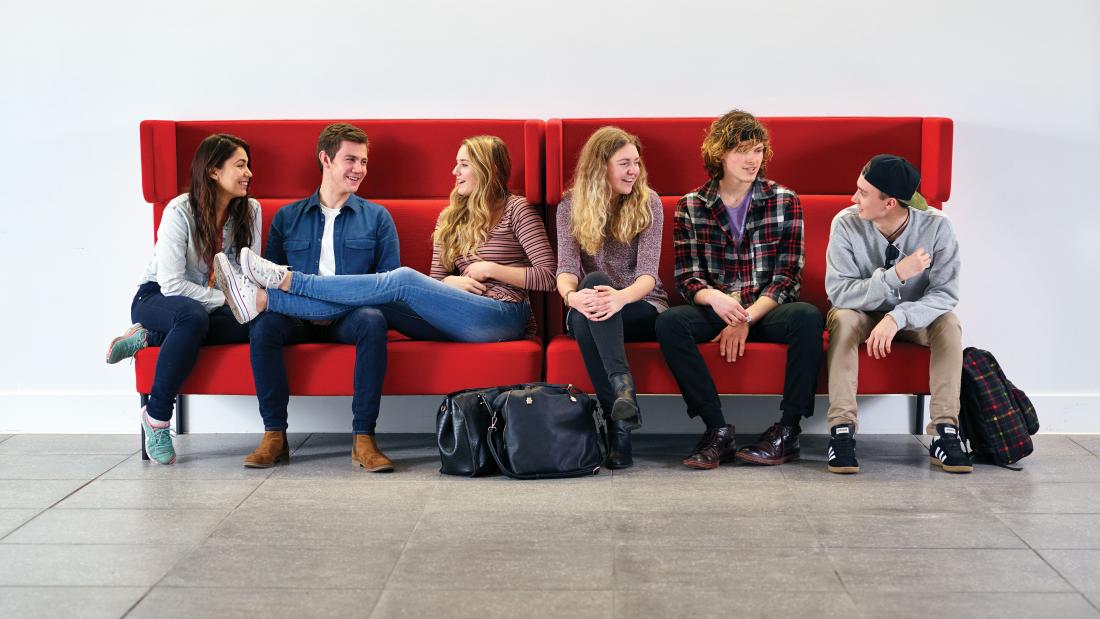 Students sitting on a sofa in Pontio