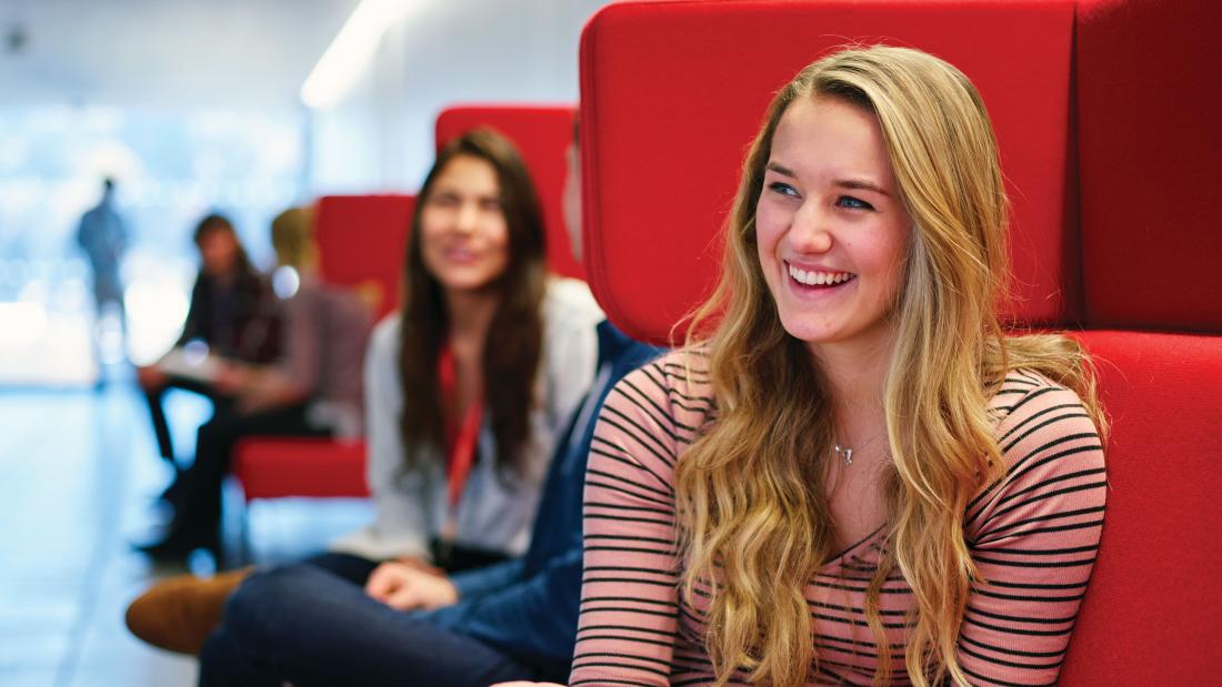 Students socialising and studying on sofas in Pontio