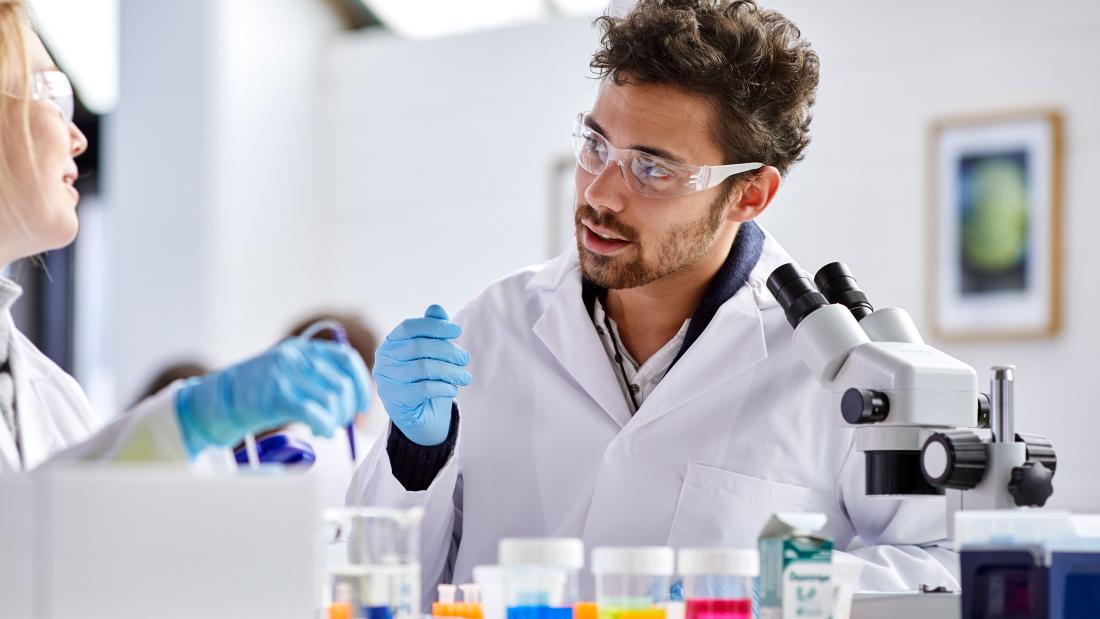 A couple of students discussing their work in a lab