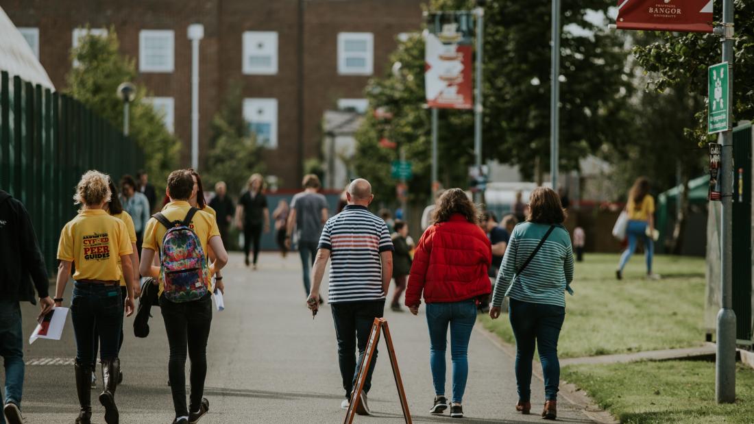 Peer Guides and new students walking through the Ffriddoedd Student Village during Welcome Week