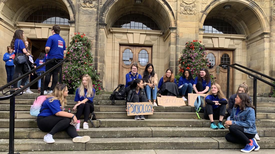 Student Peer Guides sitting outside the Main Arts Building during Welcome Week