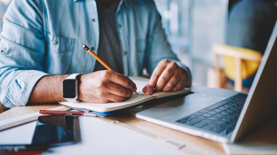 Person writing at a desk