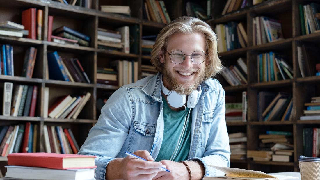 Smiling student studying in the library