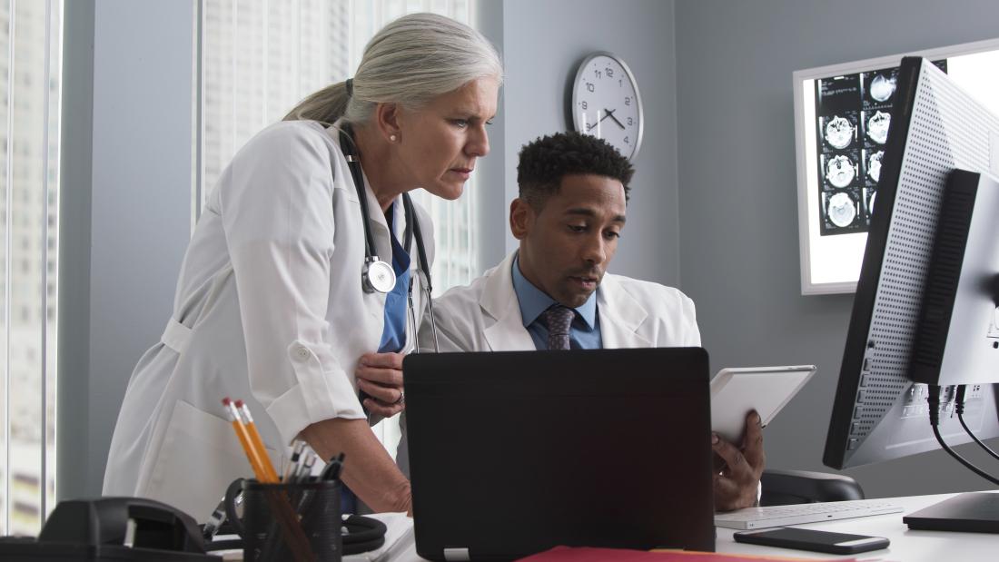 Clinical medical setting. People looking at scans.