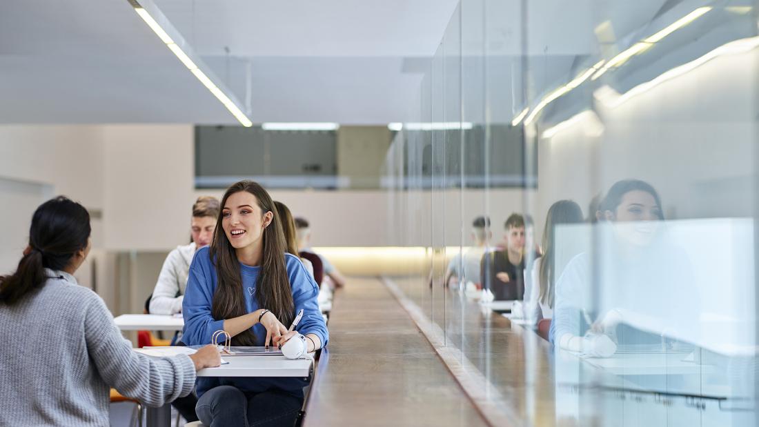 two students chatting in social learning space