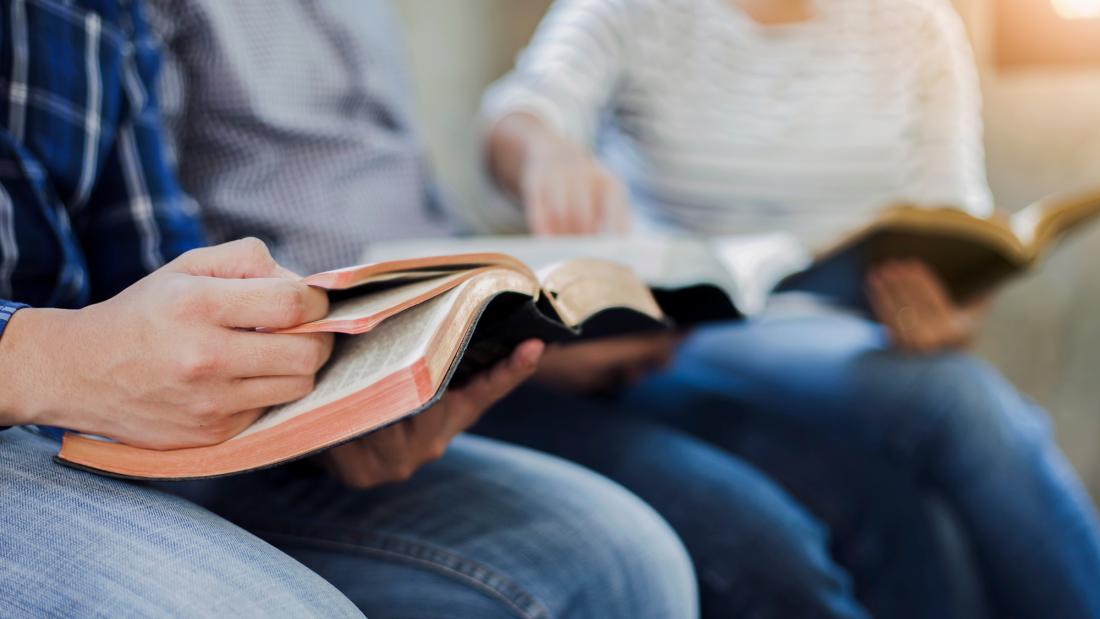 Close-up  on the hands of someone reading a book 