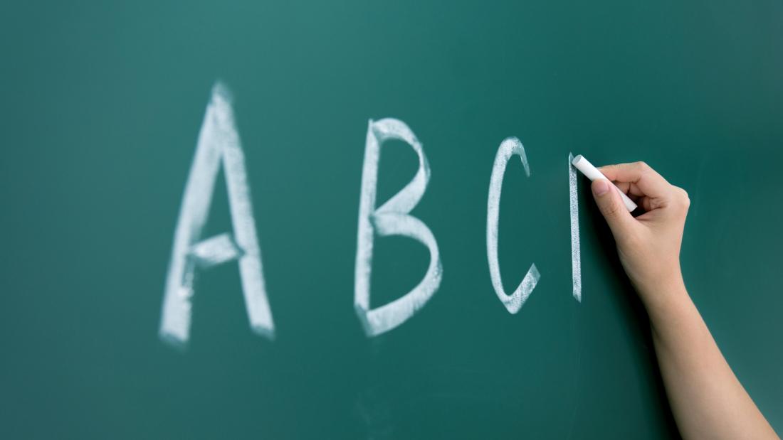 Writing A,B,C's on classroom blackboard