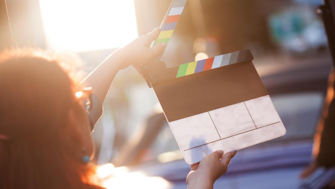 Woman holding a clapperboard