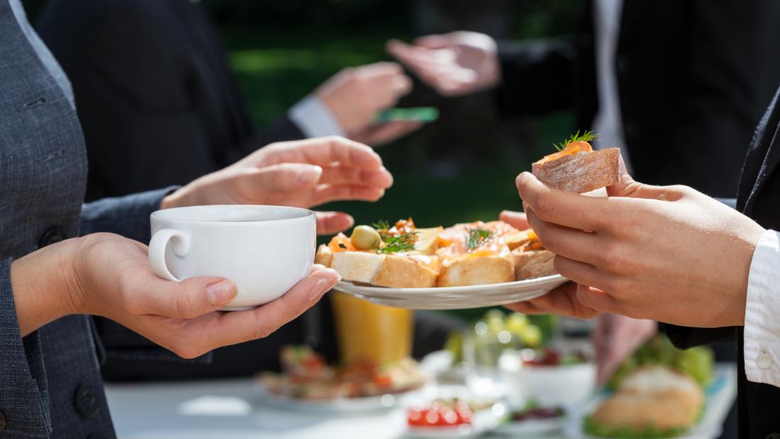 Colleagues chatting over a business buffet lunch