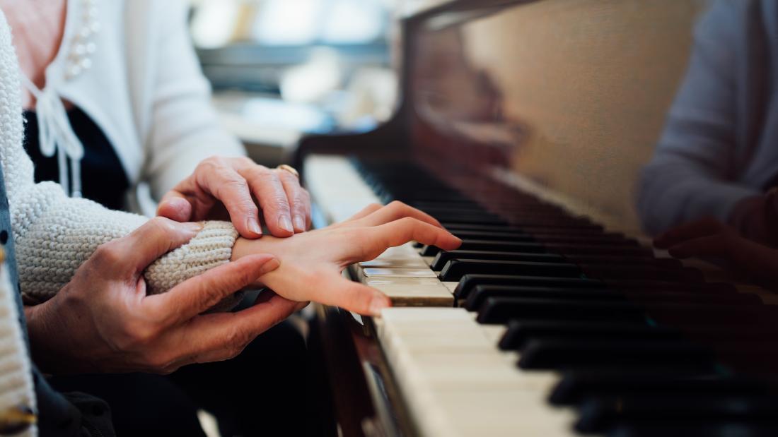 Pupil learning to play piano