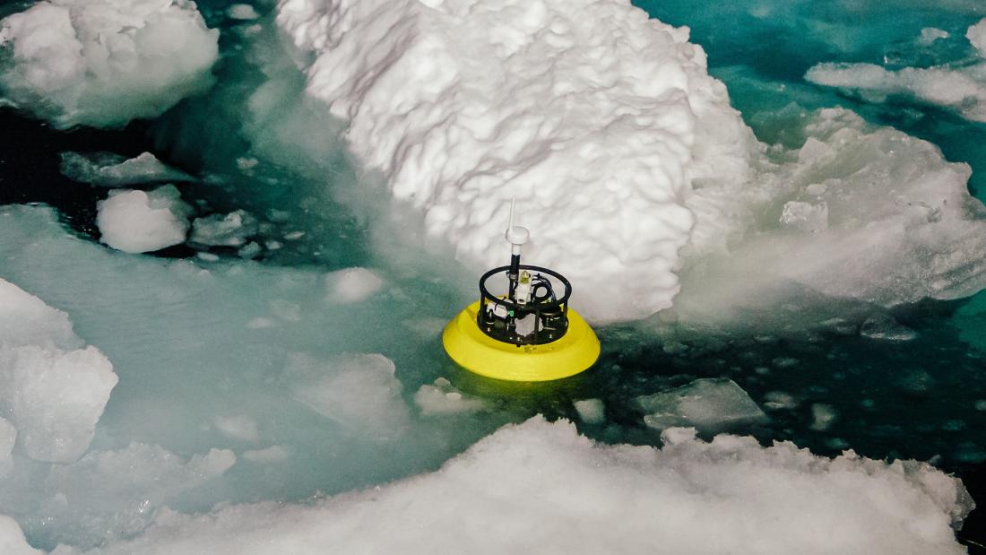 Scientific equipment seen in the water next to a piece of ice berg