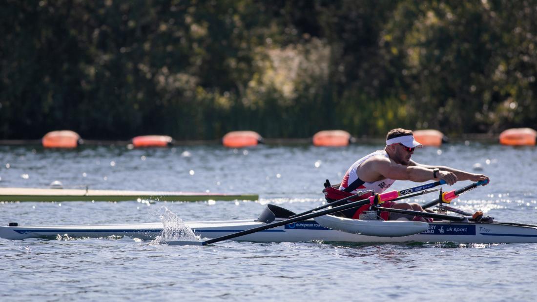 Man in single scull rowing boat