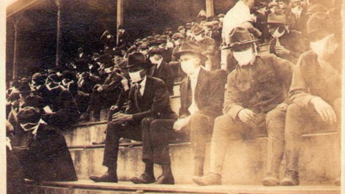 Historic image of crowd in football game 1918 wearing masks