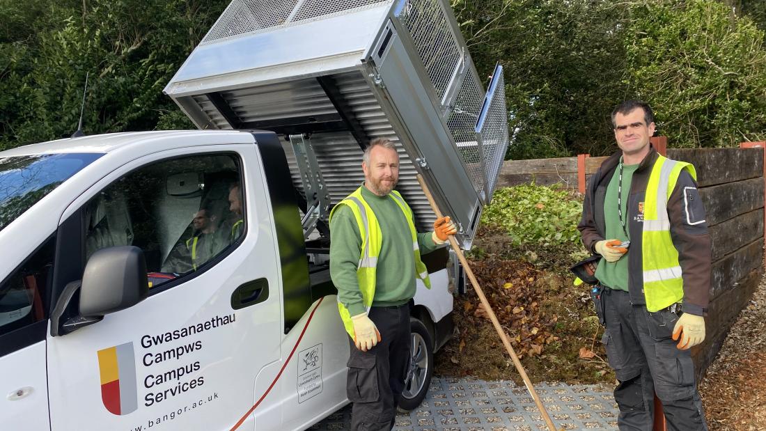 An electric vehicle with members of the operations team