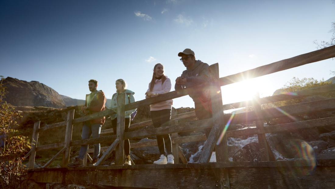 Students in Snowdonia standing on a footbridge