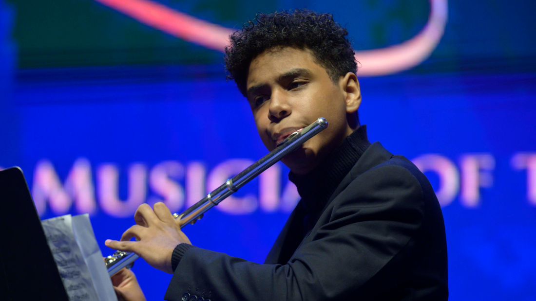 young man playing the flute