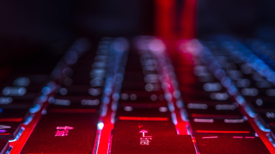 Zoomed in keyboard with a person's silhouette in the background