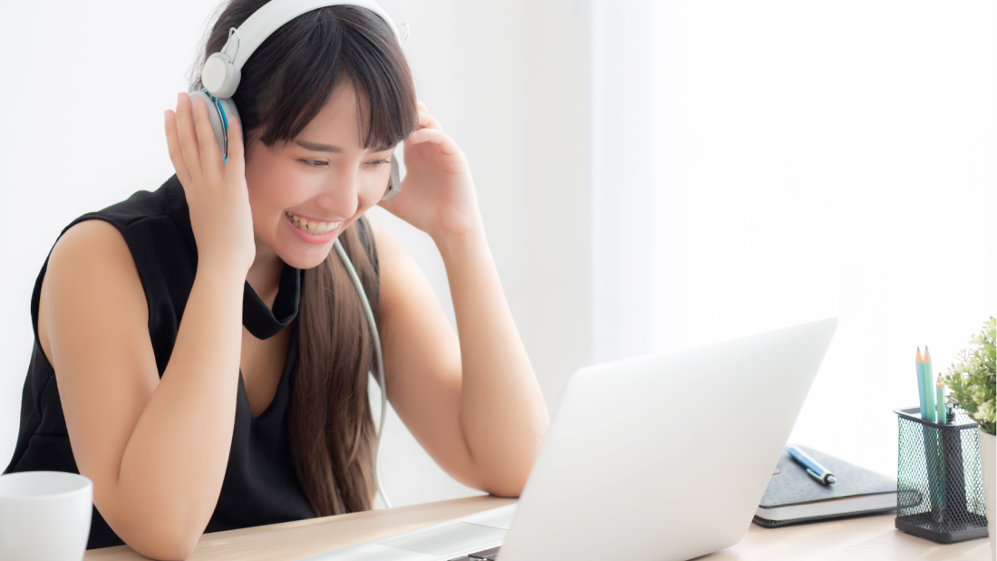 Woman with headphones with a laptop on the desk