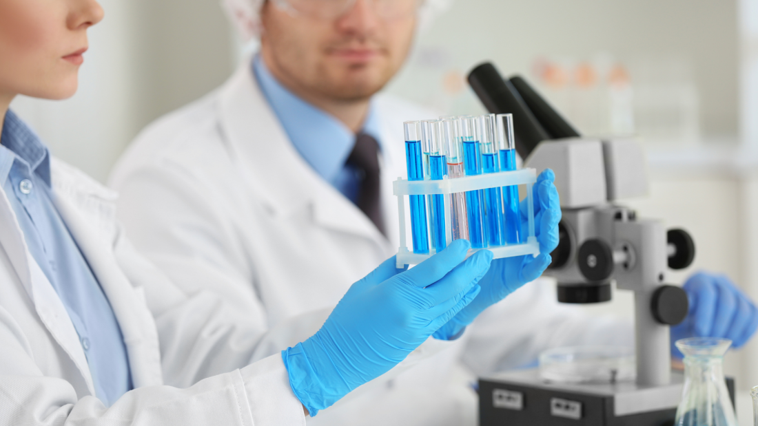 Female holding test tubes in a lab