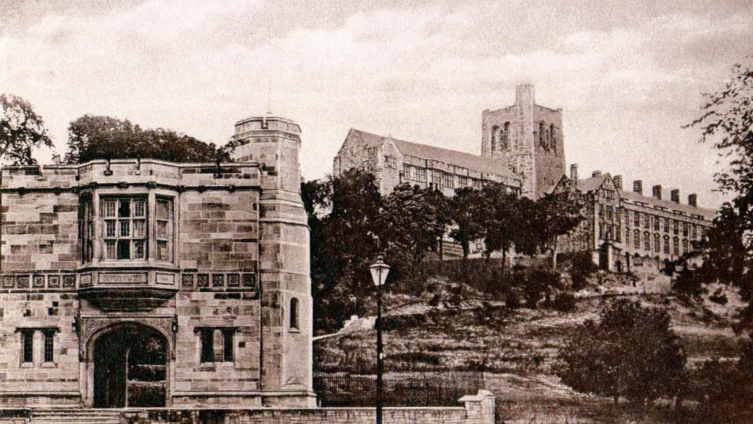 an old photograph of Bangor University's Arts building with the Memorial Arch in the foreground