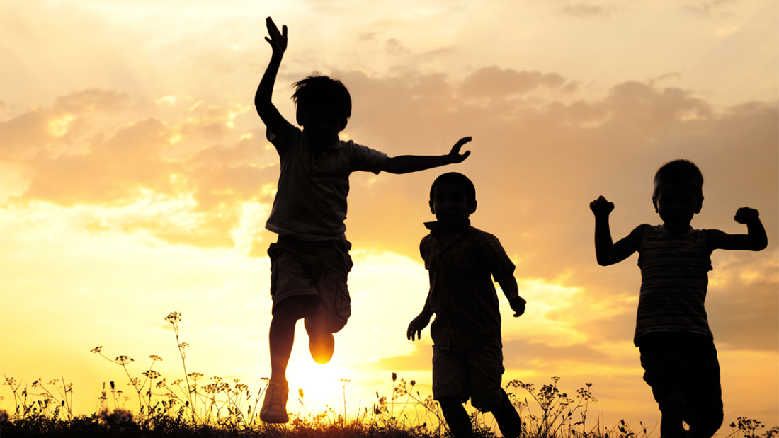 Children playing at sunset/dawn