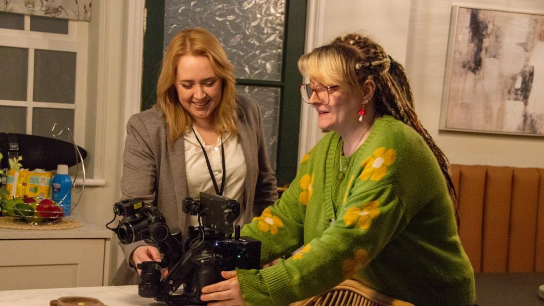 A student being shown a camera at Aria Film Studios