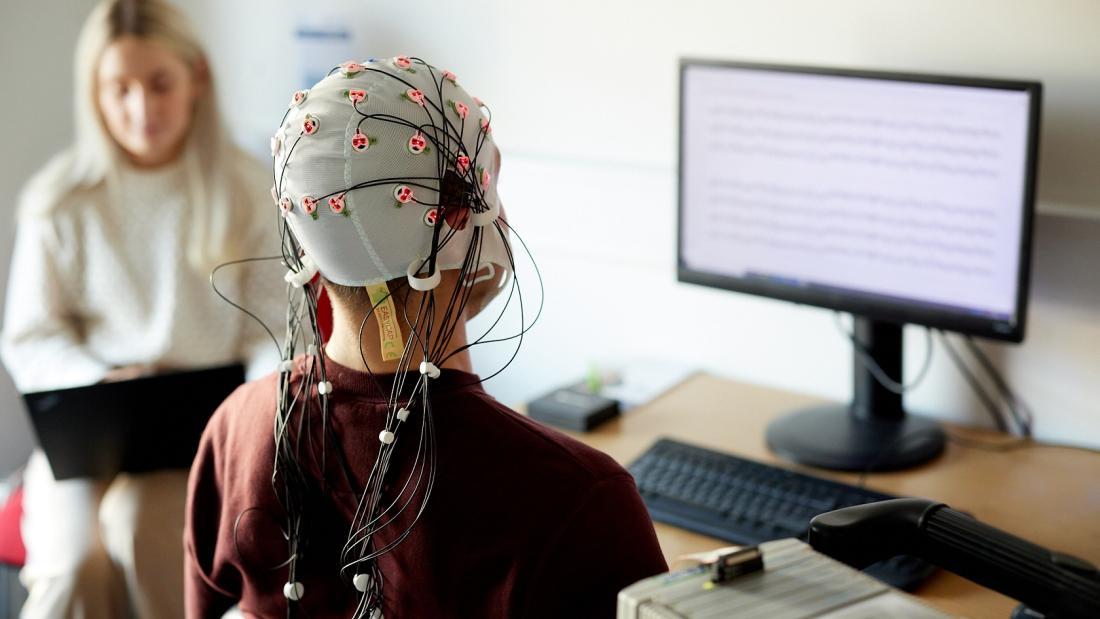 A person is fitted with an electrodes cap in the ERP lab in Bangor University