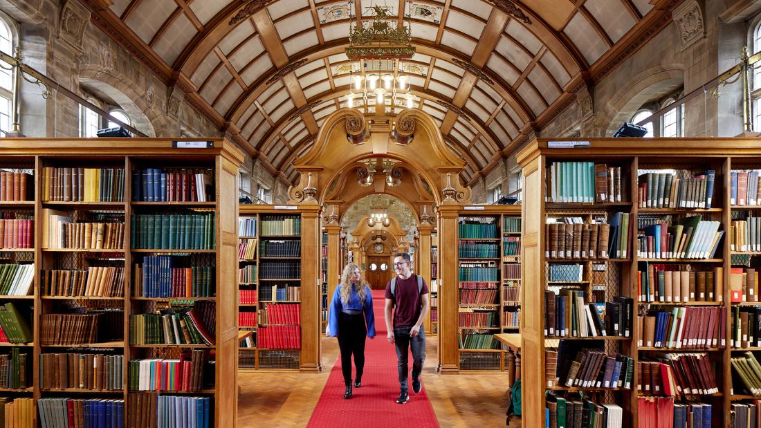 Two students walking through Shankland Library