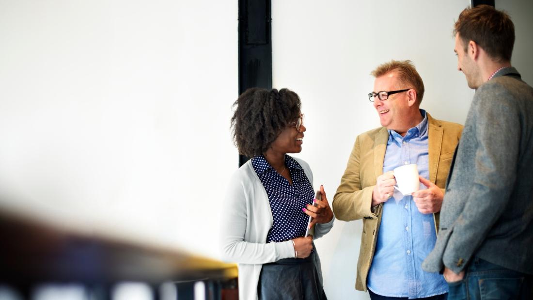 a picture of three people discussing 