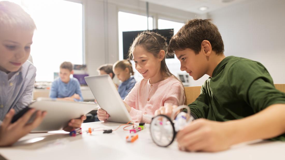 Group of young children learning at a desk