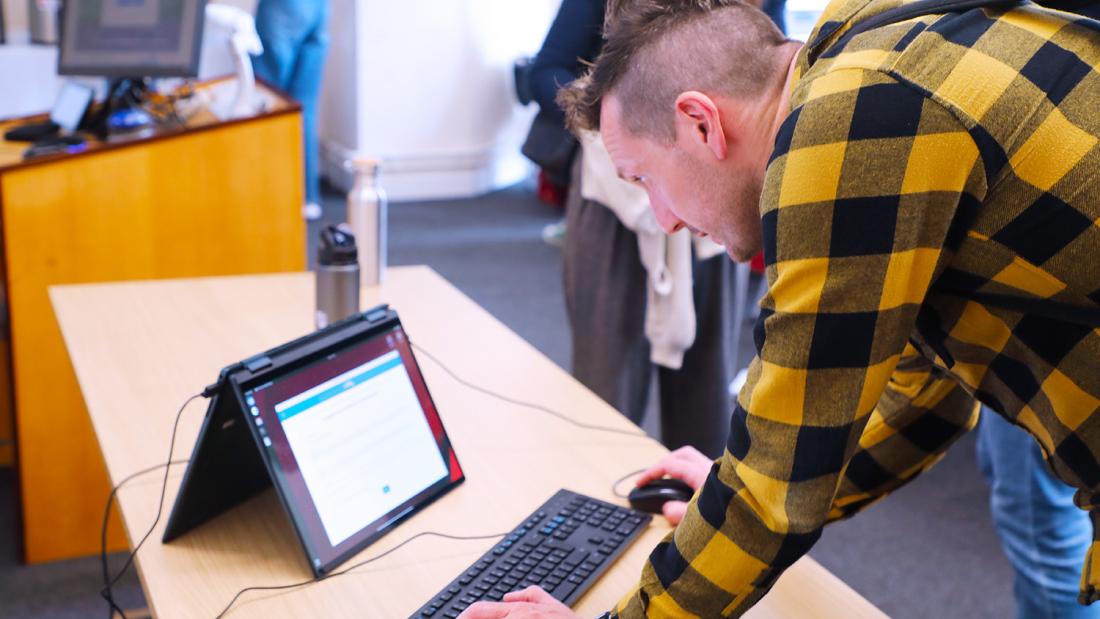 Person using a keyboard and mouse whilst looking at a desktop app