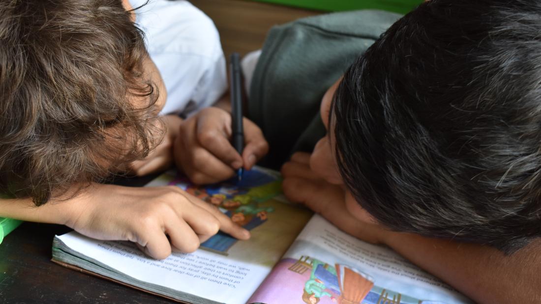 two boys working at a desk