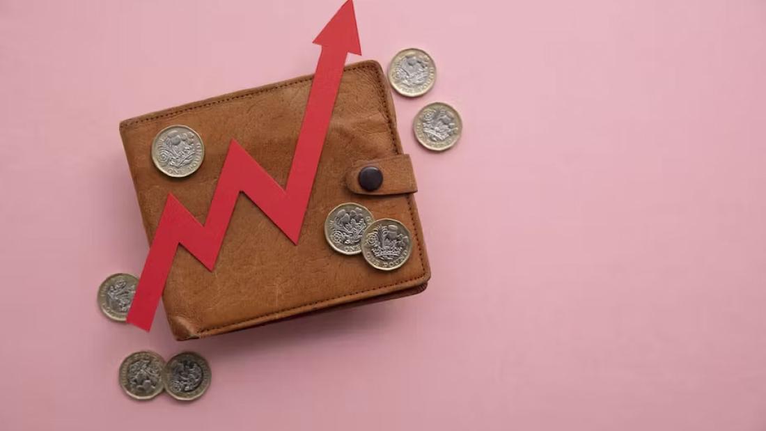 Picture of a wallet with coins and a red arrow going up on top of it