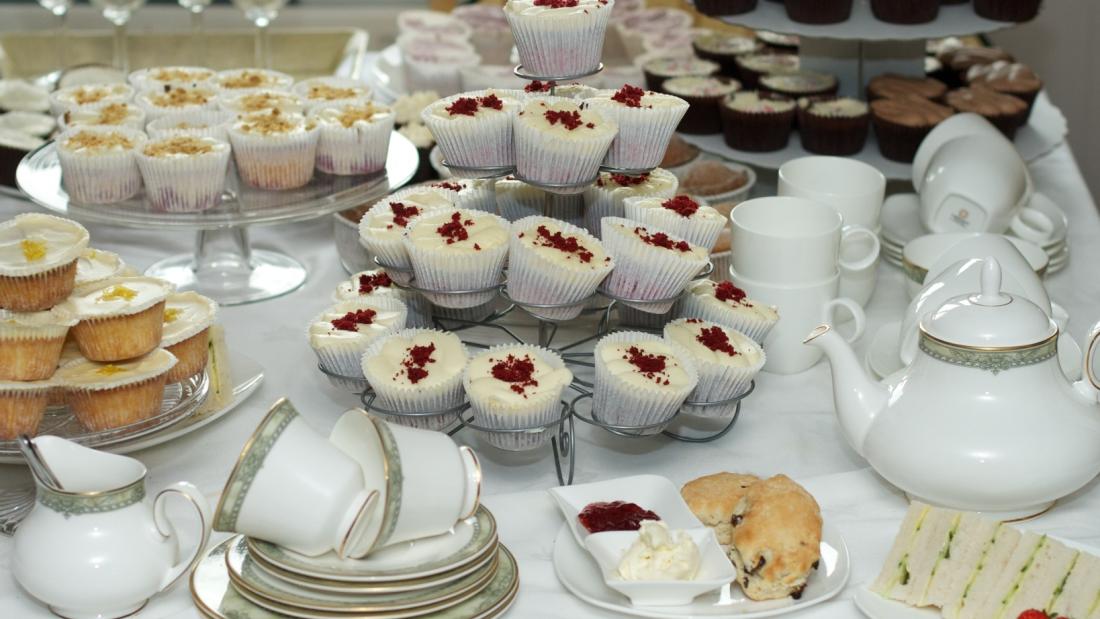 An image of cakes, cups and teapots