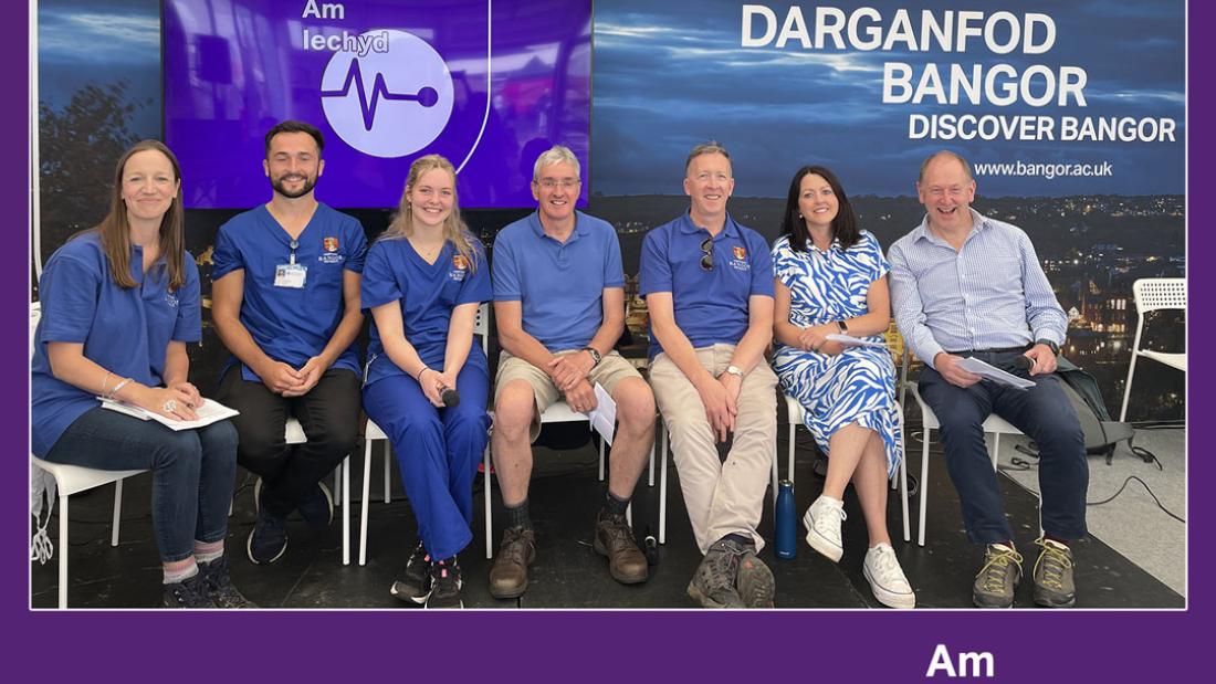 Seven people sit in a row in a purple frame below which are the words Ap Iechyd (for health) and the podcast logo.