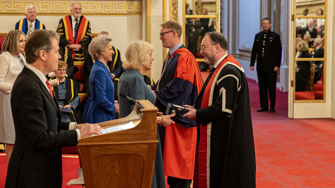The Vice-Chancellor and Professor Davey Jones receiving the medal and certificate at the Queen's Anniversary Prize ceremony at Buckingham Palace